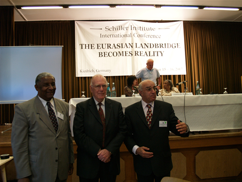 18. Mr. LaRouche with former State Senator Joe Neal (left) and conference speaker Pirouz Zadeh (right)